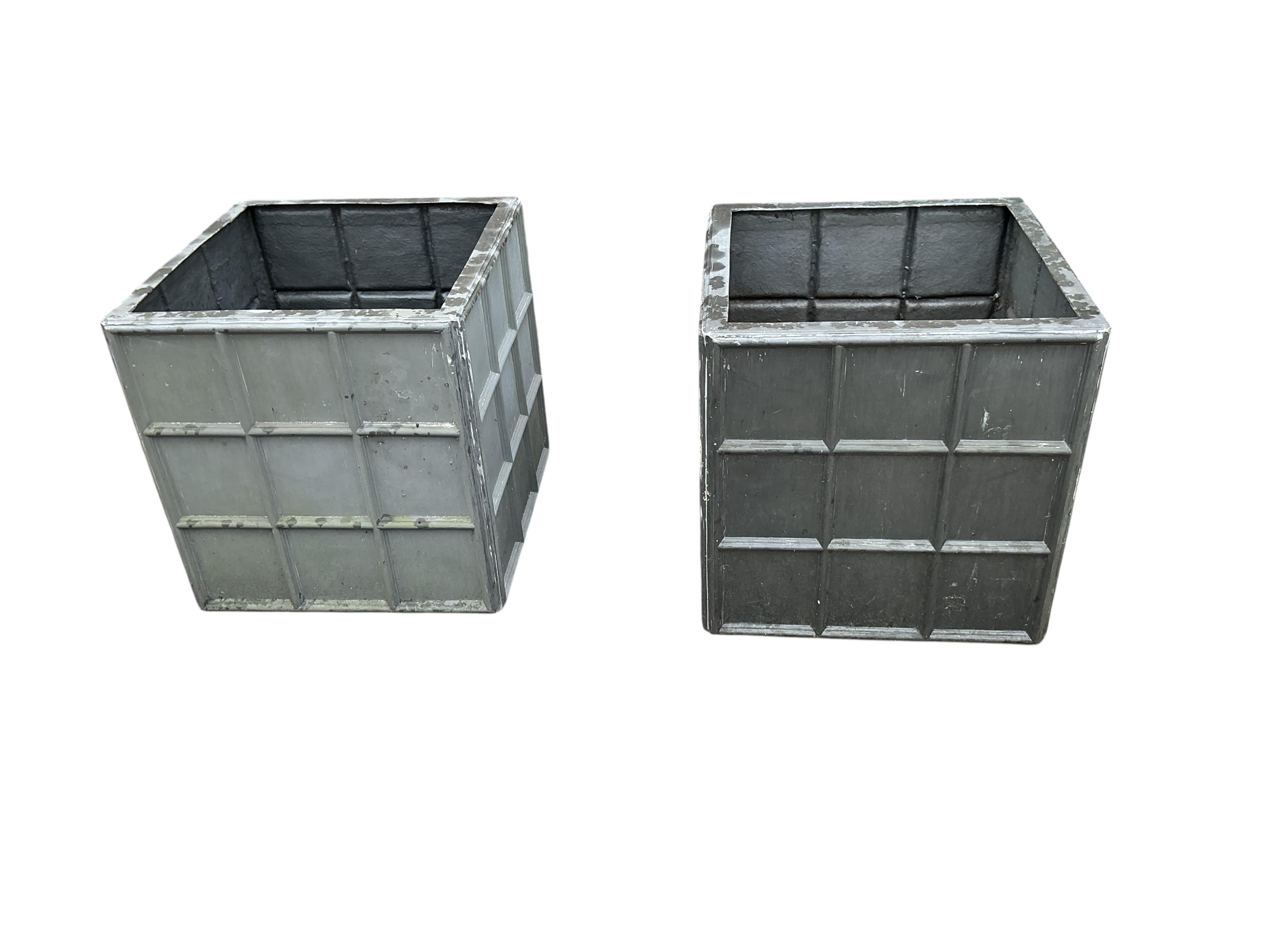 A pair of modern fibreglass faux lead garden planters, width 69cm, height 60cm